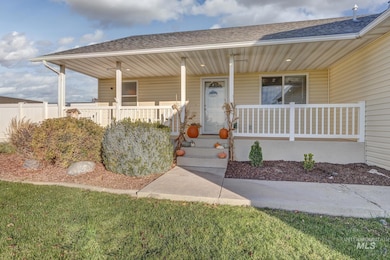 Entrance to property with roof with shingles and a porch