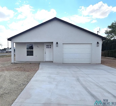Ranch-style home with driveway, a garage, and stucco siding