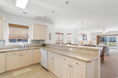 Kitchen with white dishwasher, hanging light fixtu