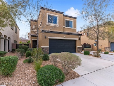 View of front of home with driveway, stone siding,