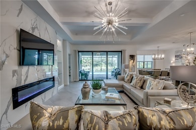 Tiled living room featuring a tray ceiling and an