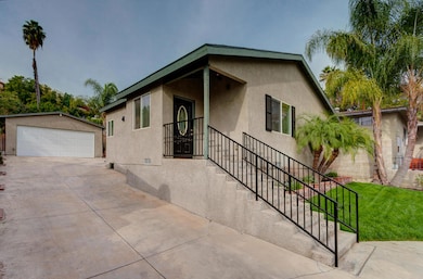 Large Driveway Leading to 2 Car Garage