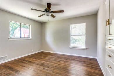 The master bedroom has built in storage with gold hardware.