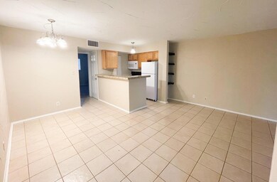 Kitchen with white appliances, light tile pattern
