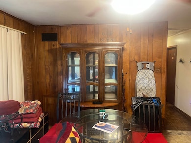Dining space with wood walls and baseboards