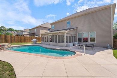 View of front of home with brick siding, driveway, and a front lawn