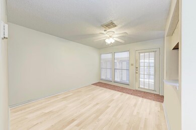 Spare room with wood finished floors, a textured 