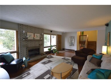 Spacious living room with grand fireplace and hard