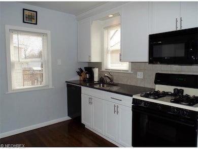 Beautifully updated kitchen with white cabinets, g