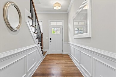 Doorway to outside featuring stairs, crown molding