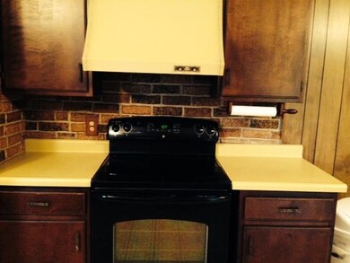 Newer stove has brick wall accents.