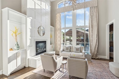 Living room featuring a towering ceiling, hardwood and a wealth of natural light