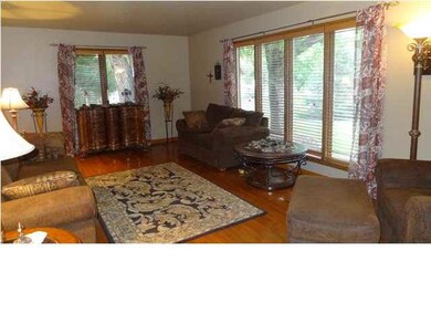 The living room features new solid wood flooring a