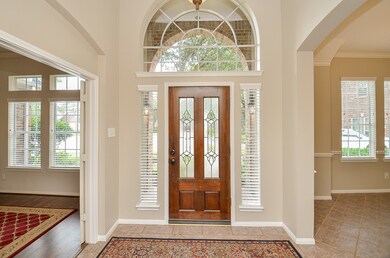 Leaded glass mahogany door protected from the elements by the covered porch. Large entry with Study on left and Dining Room on right