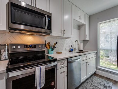 Kitchen with stainless steel appliances, white ca