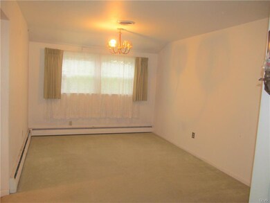 Dining room - there is hardwood under the carpetin