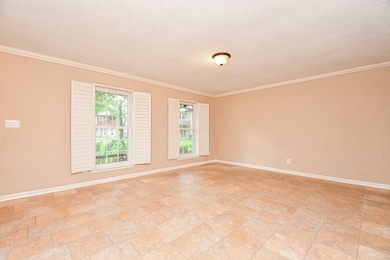 This spacious, light-filled room features neutral