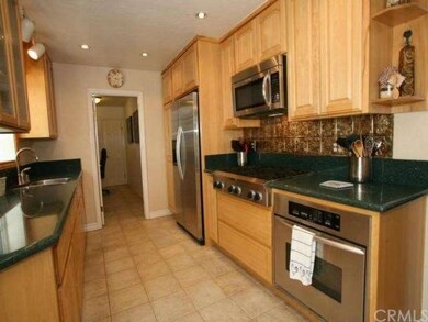 Completely upgraded kitchen with a 6 burner gas stove, stainless appliances, custom hickory cabinets with roll out functionality, tile flooring, and beautiful glass windowpane special cabinets. 