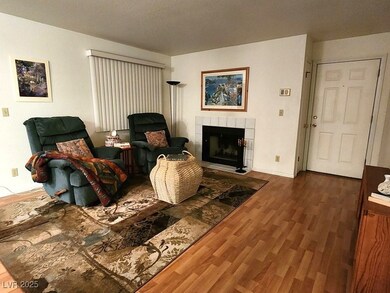 Living room with a tiled fireplace and wood finish