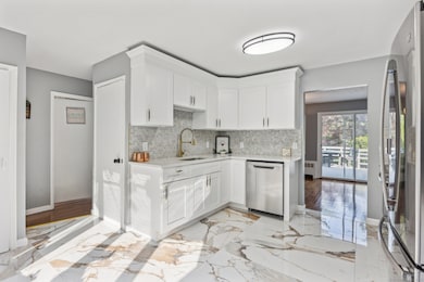 Updated kitchen quartz countertops and soft-close white cabinetry in East Hartford CT Colonial