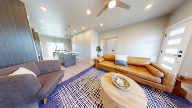 Living area featuring recessed lighting, light wood-type flooring, and a ceiling fan