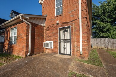 View of exterior entry featuring a wall unit AC