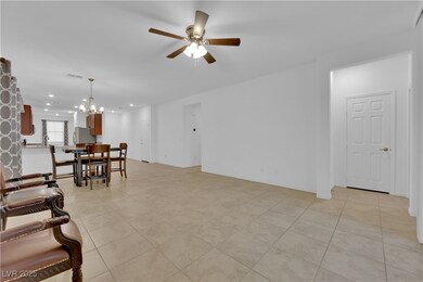 Living room featuring ceiling fan with notable cha