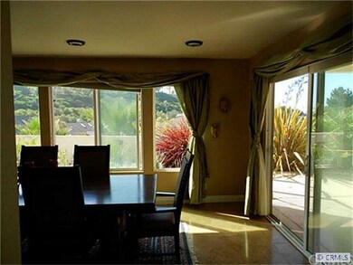 Travertine floors, sliding glass doors lead to the