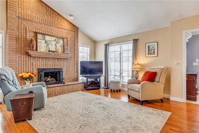 Living room with vaulted ceiling and floor-to-ceil
