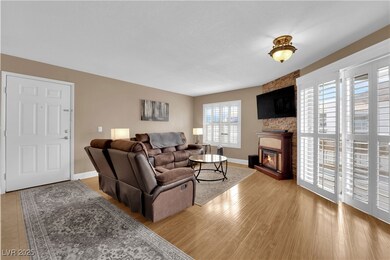 Living room featuring a large fireplace, baseboard