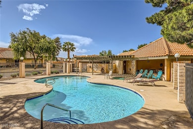 Pool with a pergola, a patio, and fence