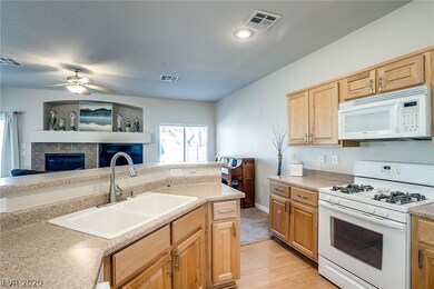 Kitchen with raised panel wood cabinets that over