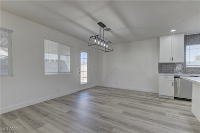 Unfurnished dining area featuring light wood-style floors and recessed lighting
