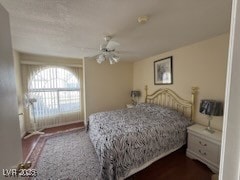 Bedroom with ceiling fan and dark wood finished floors