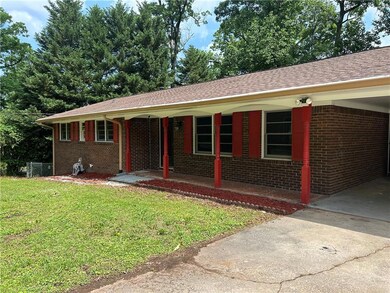 Ranch-style house featuring a carport and a front 