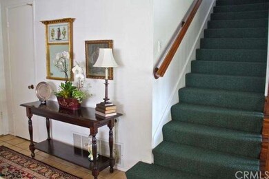 Broad entry with double doors and nearby stairway 