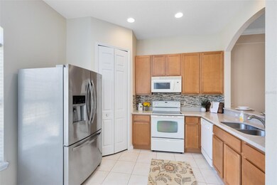 Kitchen with a new fridge, closet pantry & tile backsplash