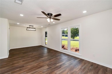 Dining Room featuring dark wood-style floors, ceiling fan, recessed lighting, baseboards, and a textured ceiling