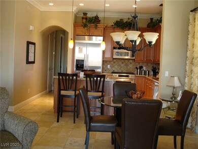 Dining area featuring arched walkways, a chandelie