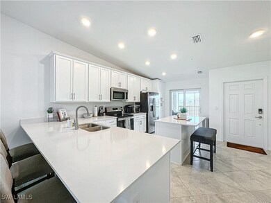 Kitchen featuring a breakfast bar, sink, kitchen p