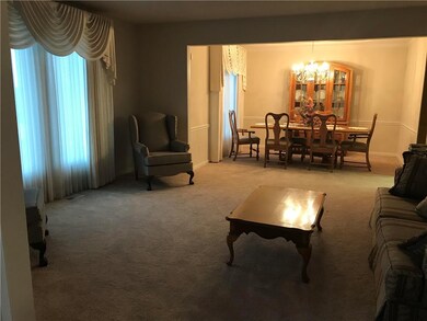 Formal living room and formal dining room makes a large area for entertaining! Right off entry - New Carpet!