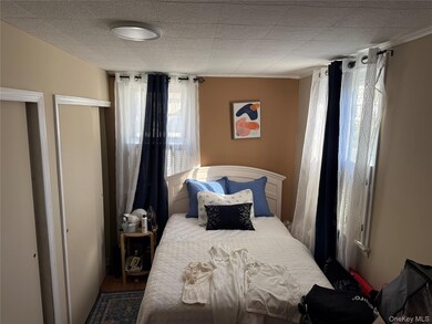 Bedroom with a closet, wood finished floors, and crown molding