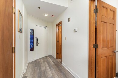 Hall with hardwood / wood-style floors