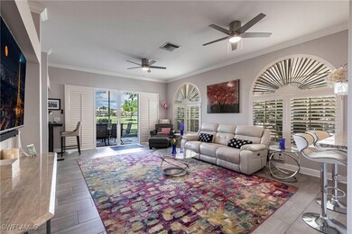 Living area with ceiling fan, ornamental molding,