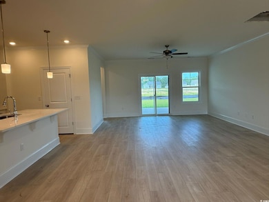 Unfurnished living room with a ceiling fan, crown molding, wood finished floors, and recessed lighting