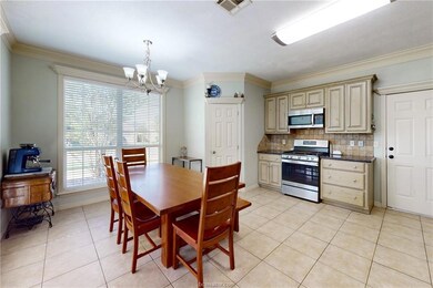 Dining room with a chandelier, visible vents, orna