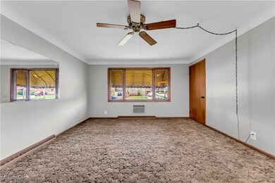 Empty room featuring carpet flooring and ceiling fan