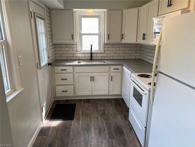 Your new galley style kitchen with new cabinets, granite counters and flooring