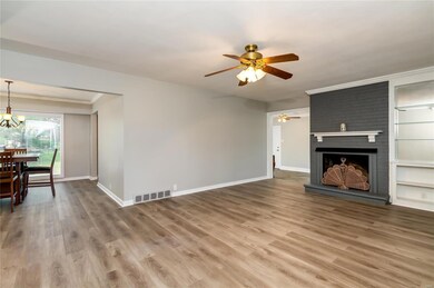 Living room with brand new vinyl flooring opens to dining room and bonus room.
