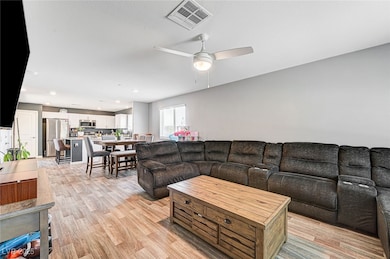 Living area featuring light wood-style floors, cei